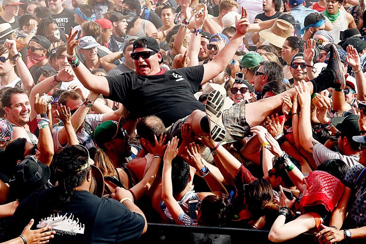 A person standing in a crowd
Description automatically generated with low confidence