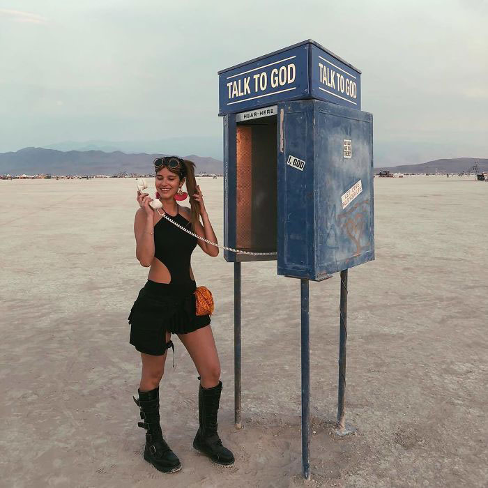 A person standing next to a pay phone
Description automatically generated with medium confidence